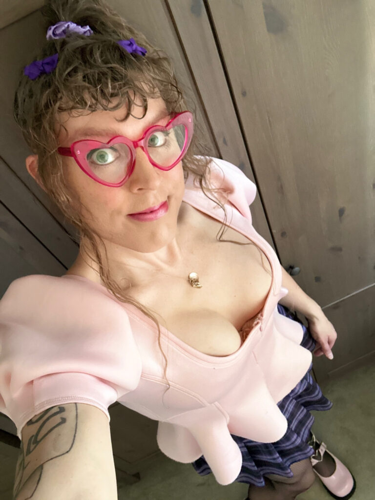 me in a low cut pink top with some v obvious and nicely sized boobies