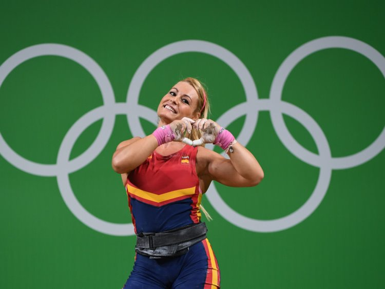 Lidia Valentin competes in weightlifting for Spain in the Olympics, she's making a heart with her hands