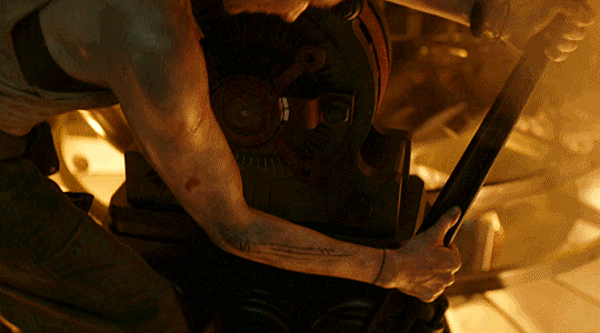 An animated gif of Juliet in the generator, pulling on a giant wrench, muscles flexed and covered in grime