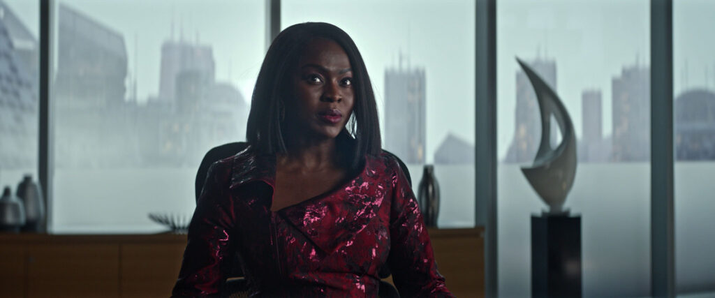 Neera, in a shimmery red dress