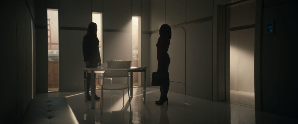 the silhouettes of una and neera in una's holding room