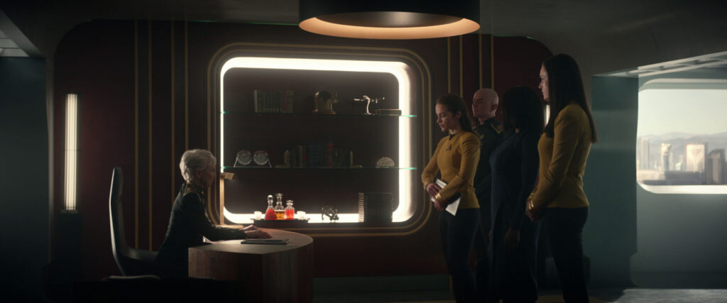 Pasalk and Batel standing next to Neera and Una, in front of the judge