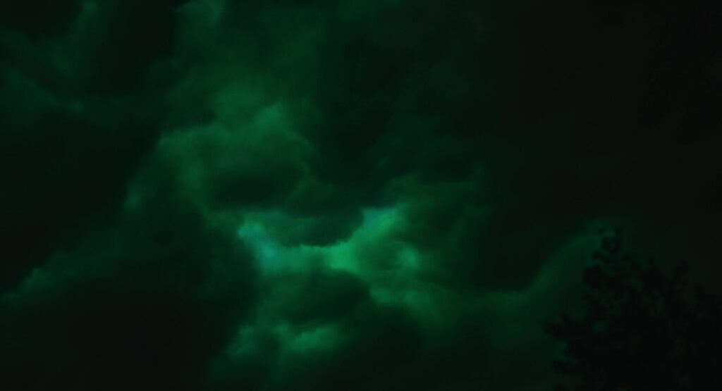 Green-blue dysphoria light in storm clouds