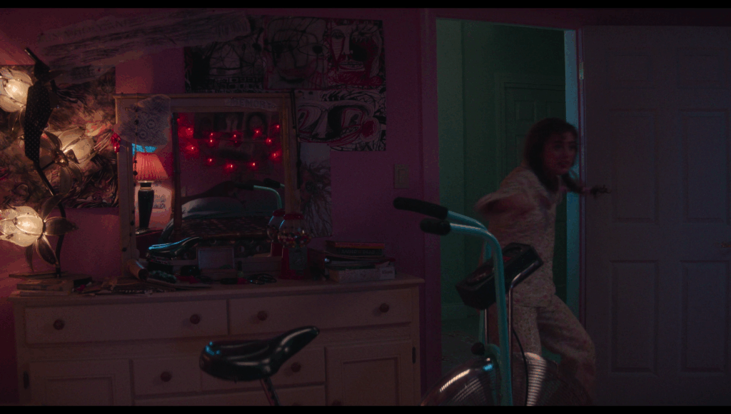 Lisa running into her pink bedroom from the green-blue hallway.