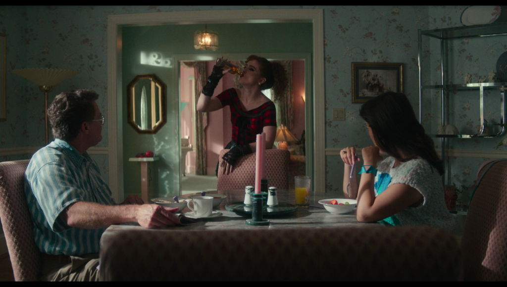 The number 25 seen in shadow on the wall in the background, as Lisa stands drinking sherry at the breakfast table where dad and Taffy eat.