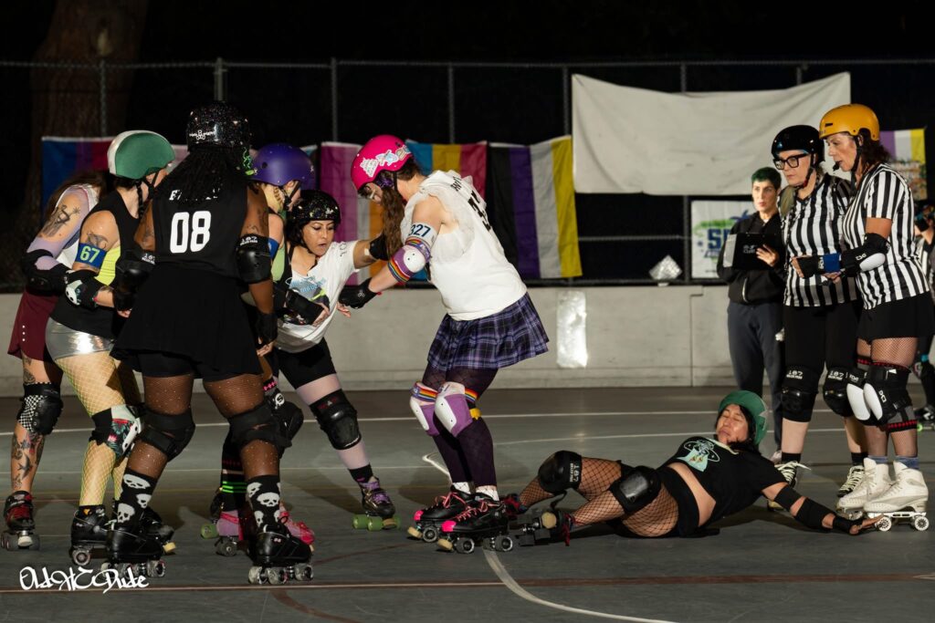 me blocking in a derby bout, having just knocked the opposing team's jammer out of bounds with my ass