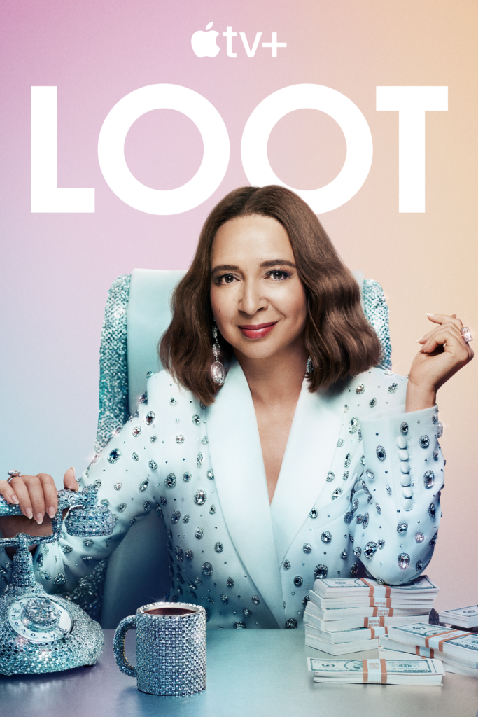 Loot season 3 poster with Maya Rudolph wearing a suit covered in diamonds, sitting behind a desk with a phone and coffee mug encrusted with diamonds, resting her elbow on a stack of money