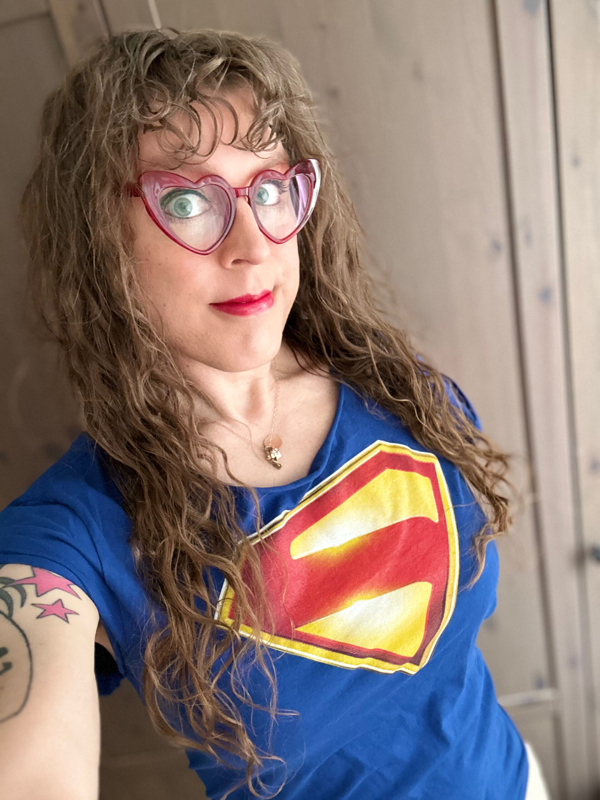 Me in a blue t-shirt with the Superman logo from James Gunn's film on it